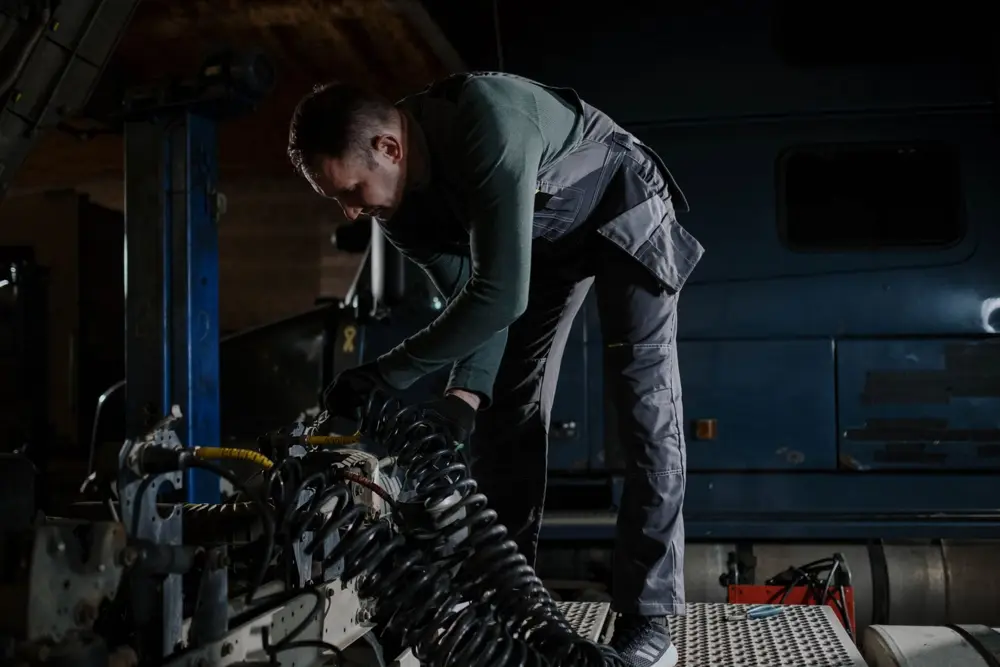 Mechanic working on a truck in a shop