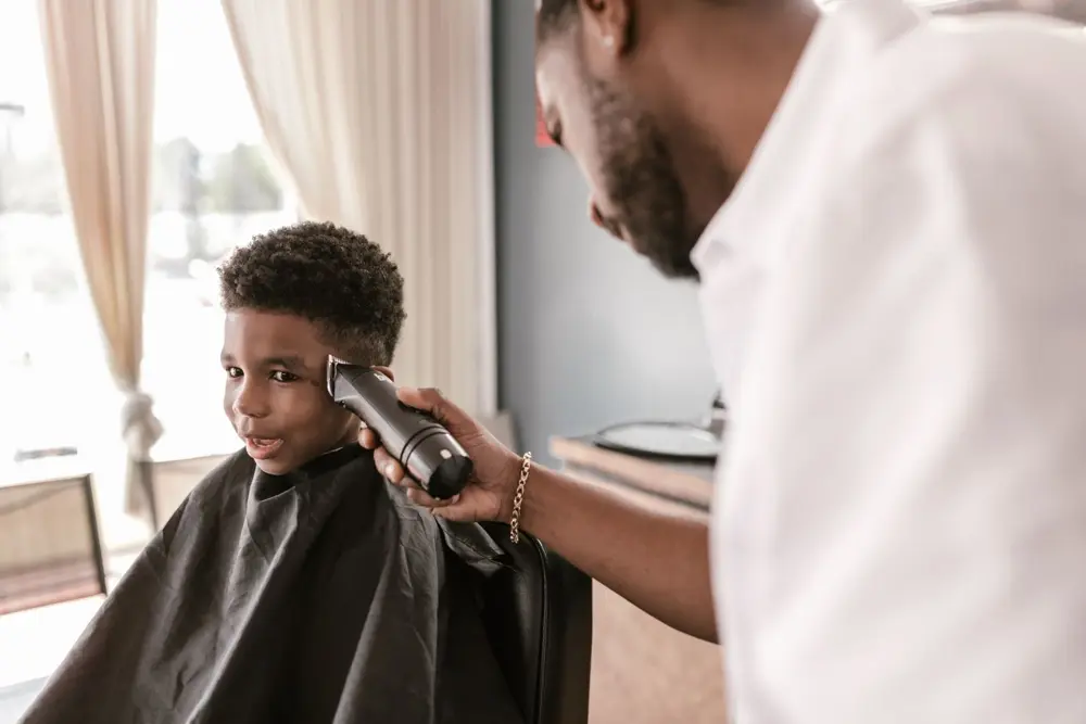 Boy getting a haircut with clippers