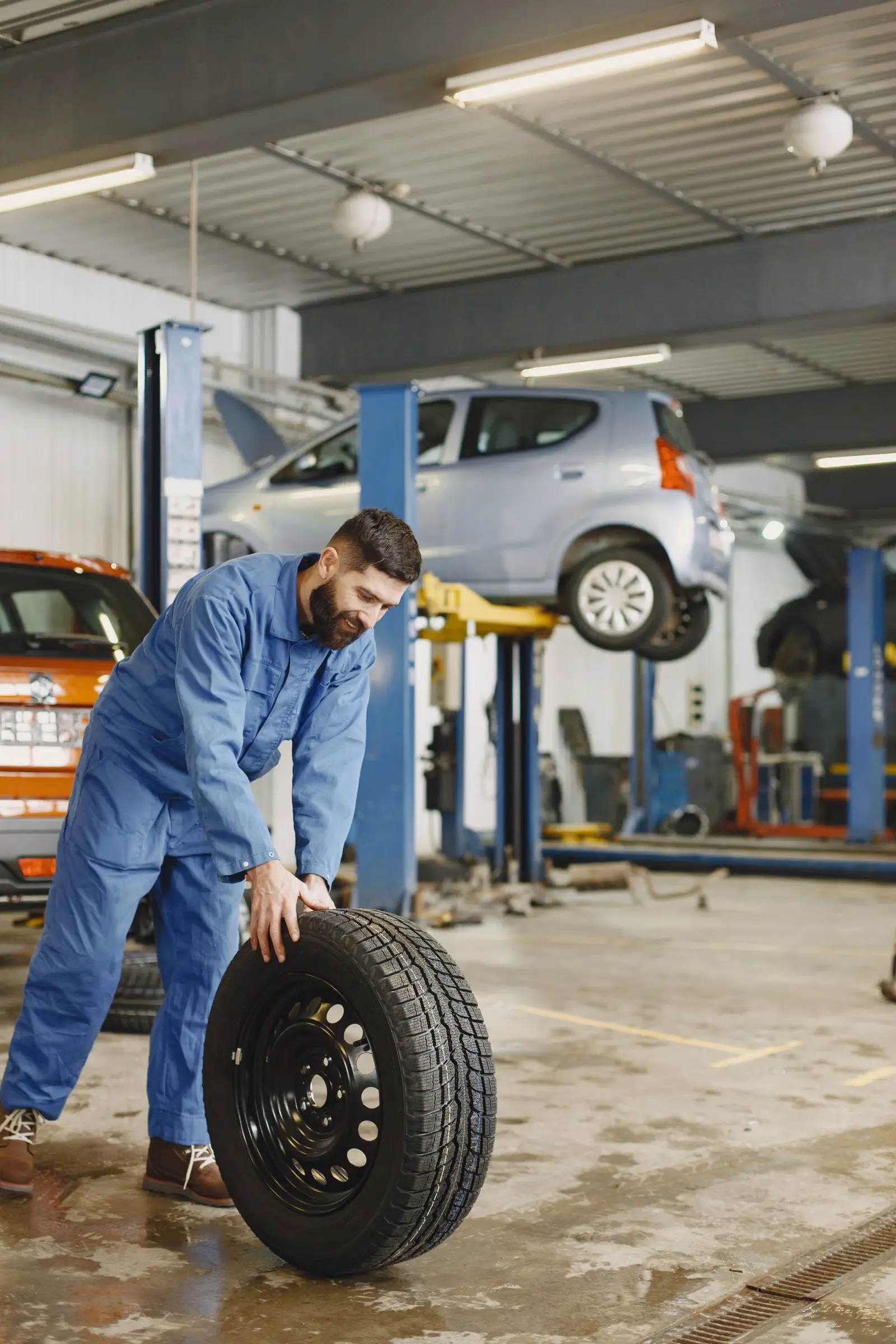 Tire technician holding a tire