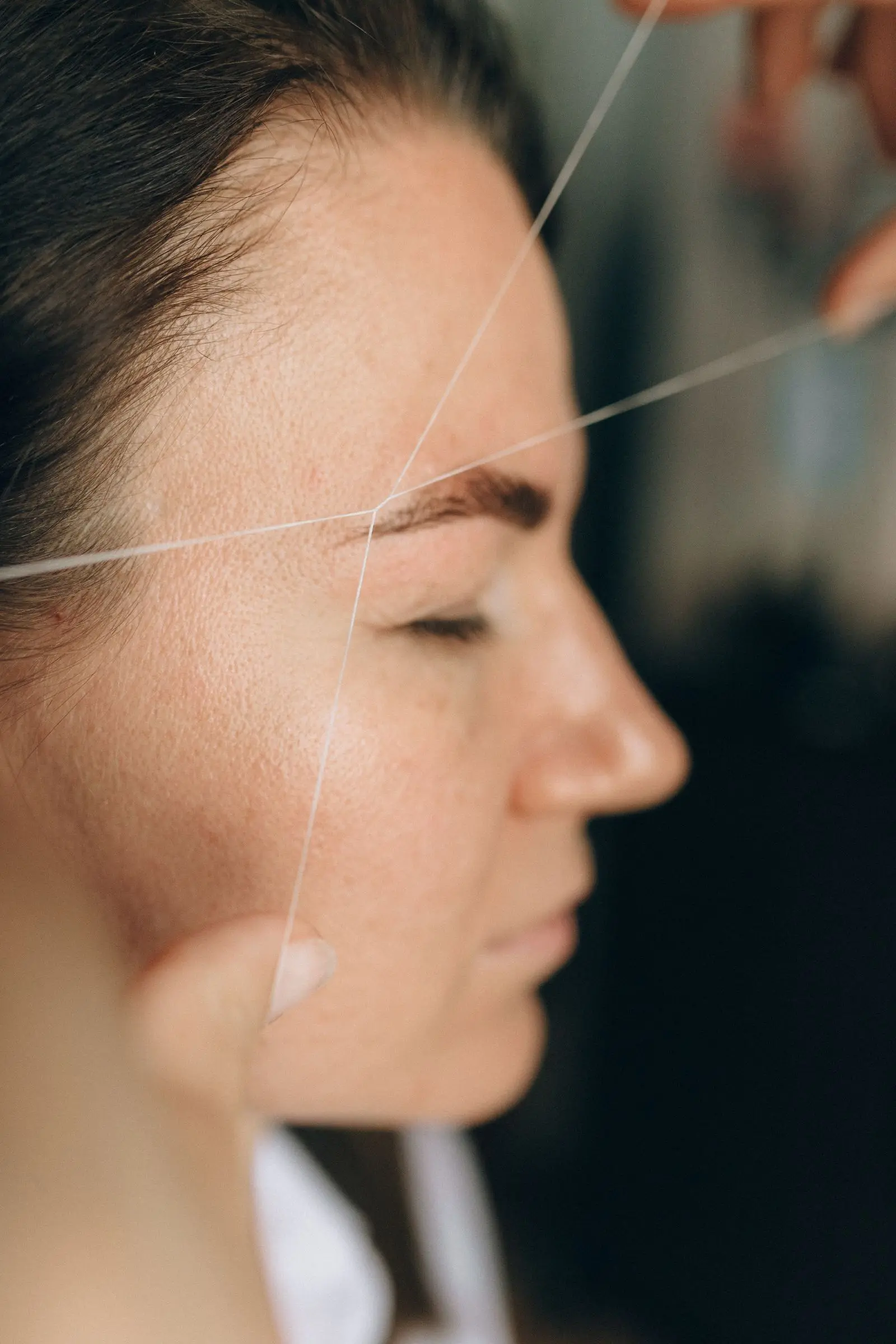 Woman having her eyebrows threaded