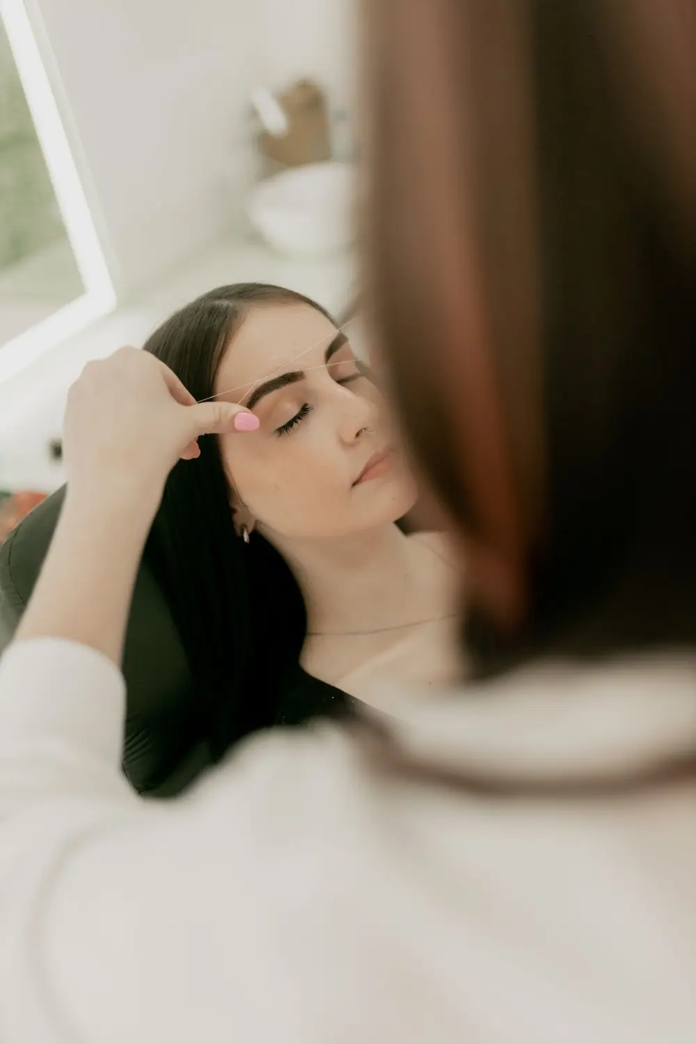 Brow shaping at a salon