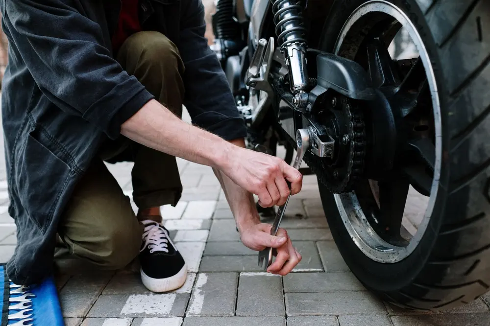 Mechanic's hands working on a motorcycle
