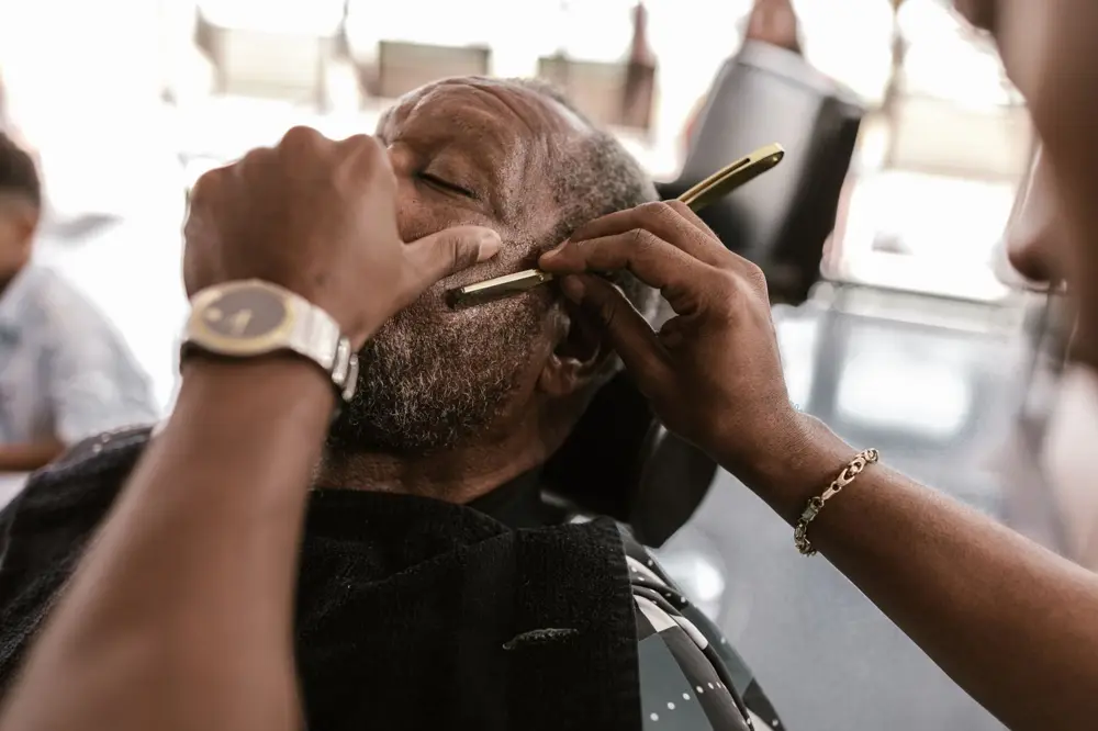 Barber giving a razor shave