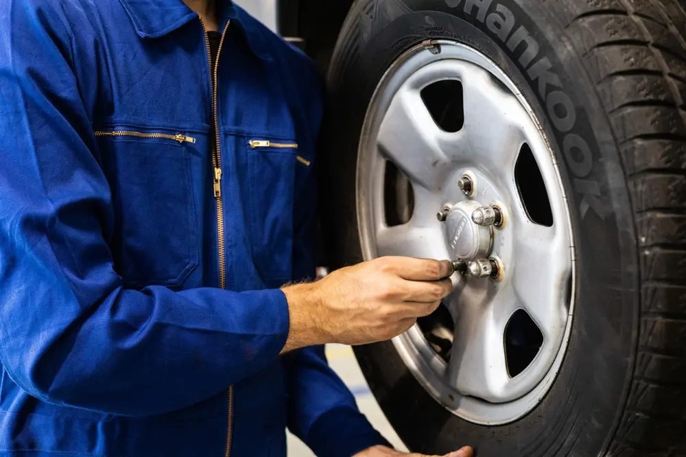 Mechanic mounting a wheel