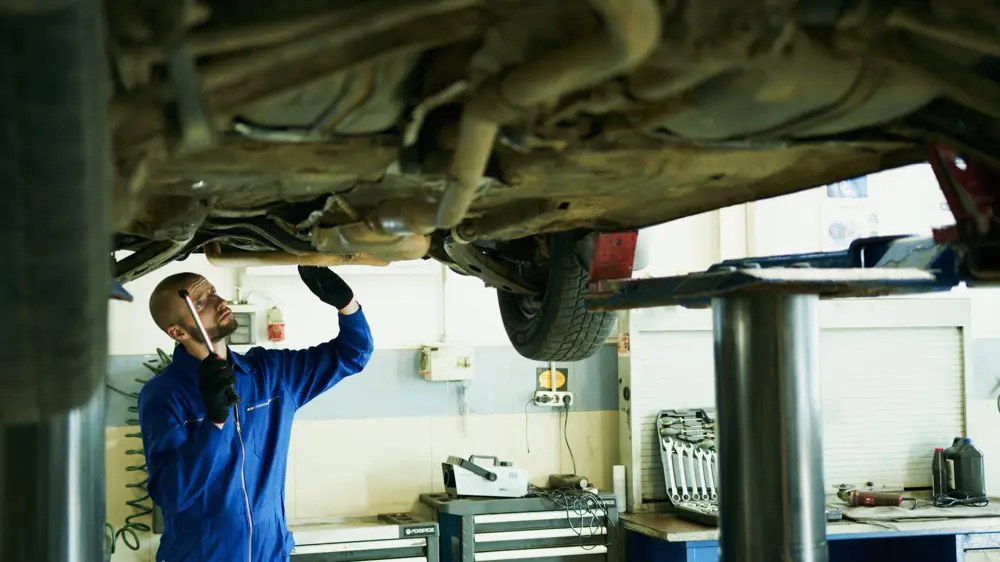 Mechanic working under a vehicle