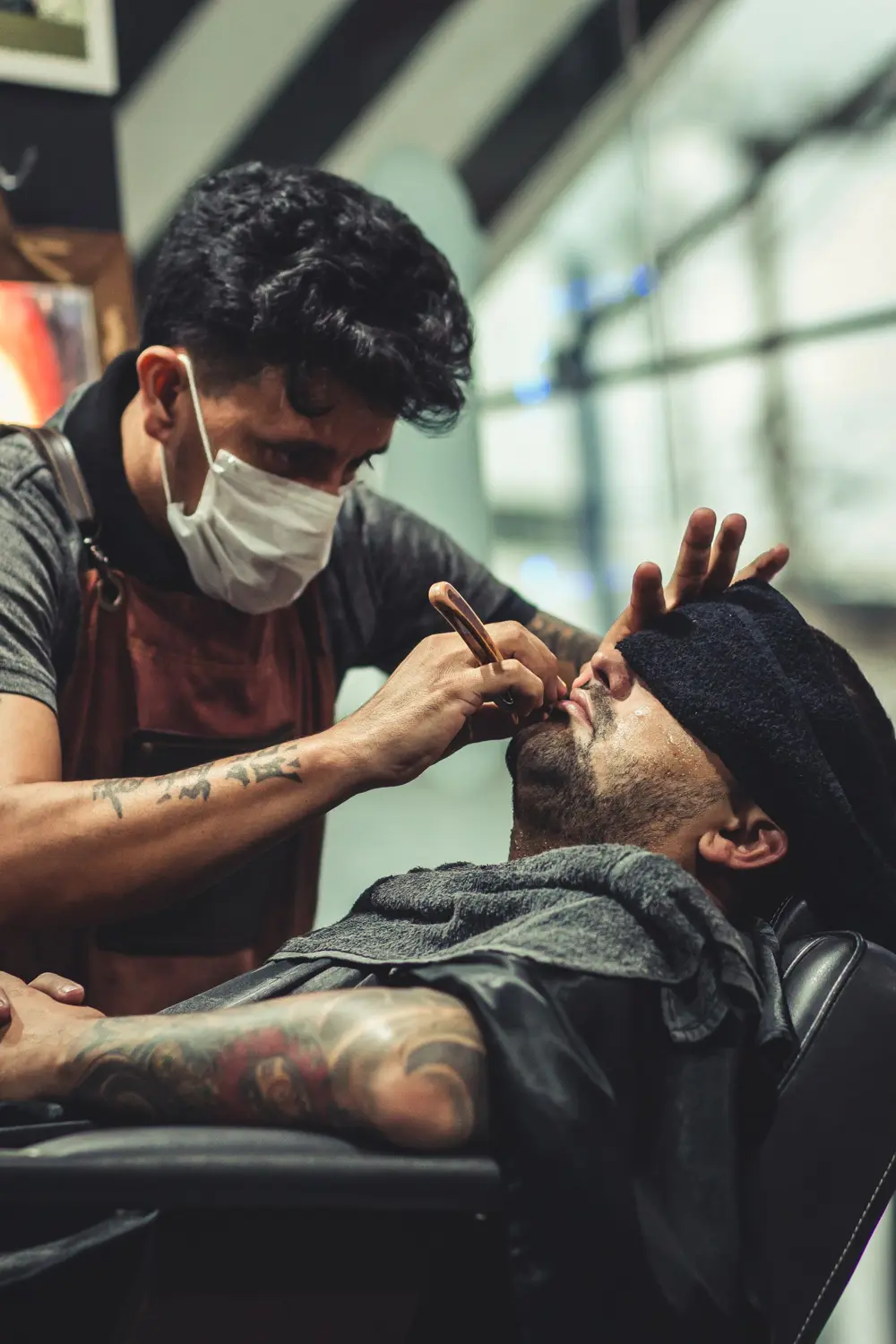 Barber giving a straight-razor shave