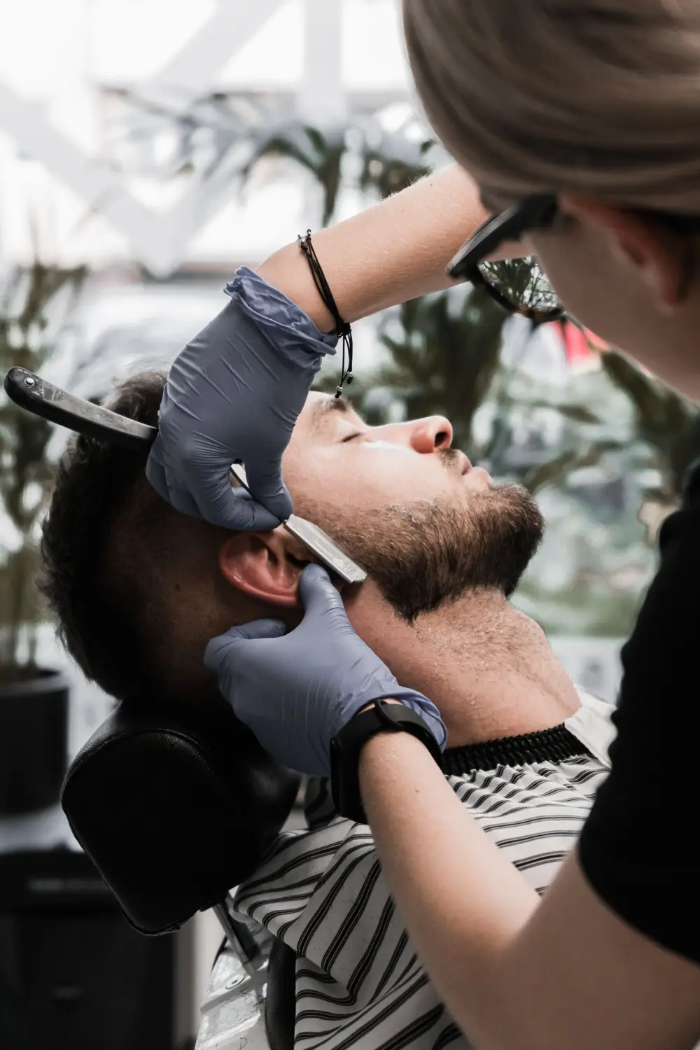 Barber shaping a beard