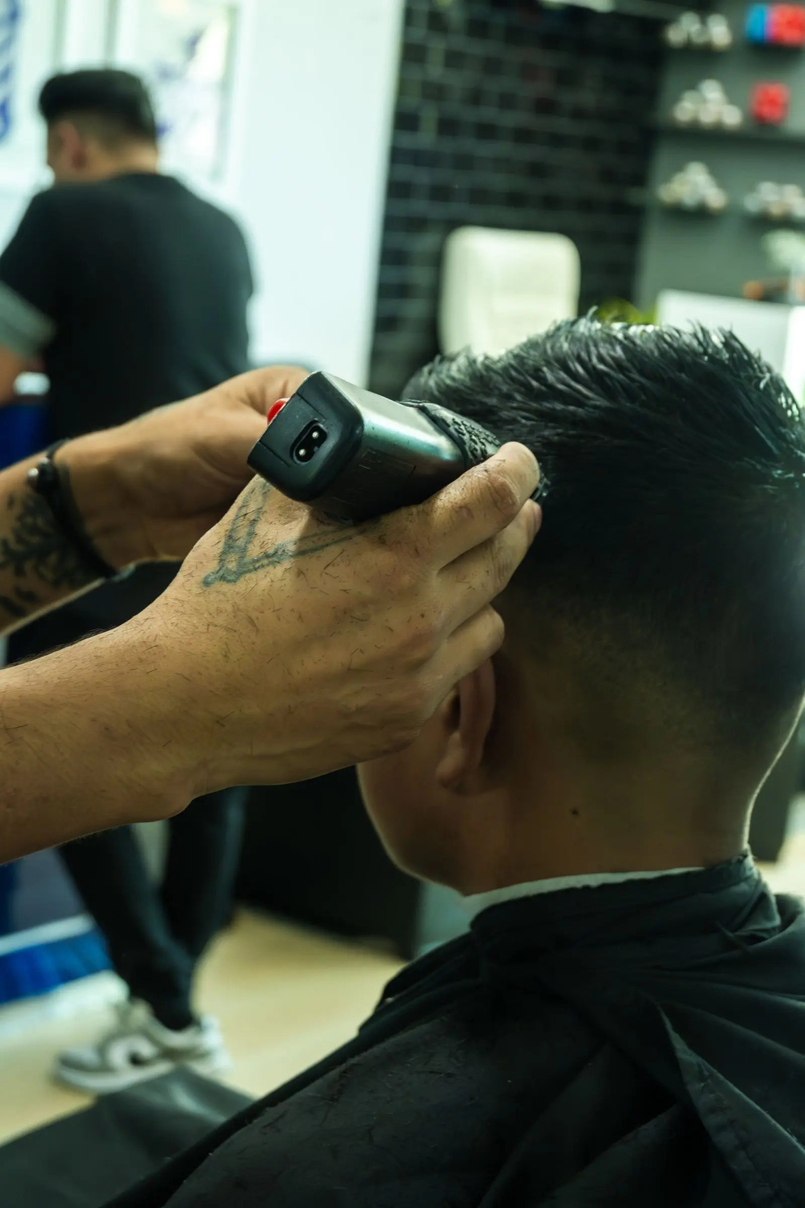 Barber trimming hair with clippers
