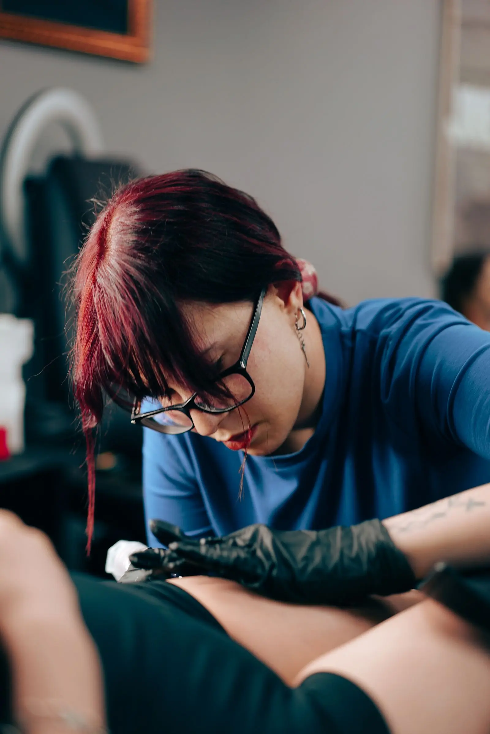 Tattoo artist working on a client