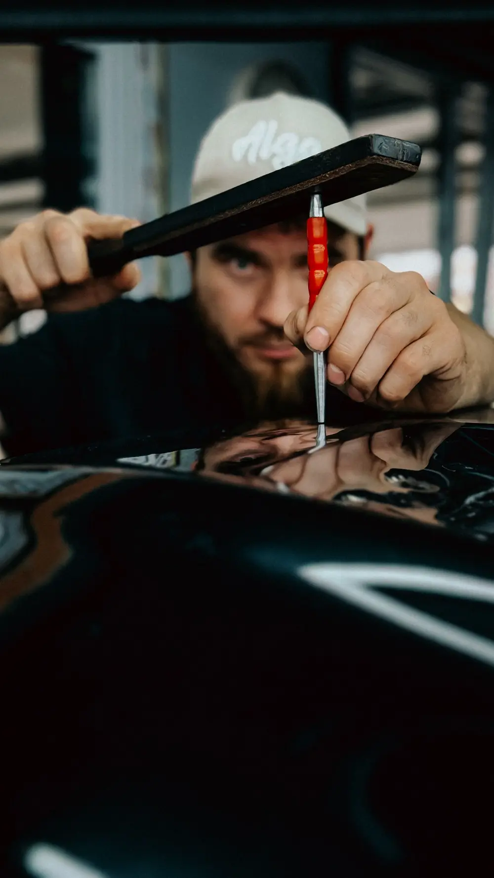 Technician repairing a car dent