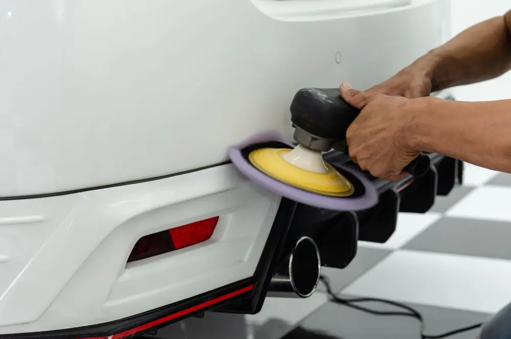 Technician polishing a car