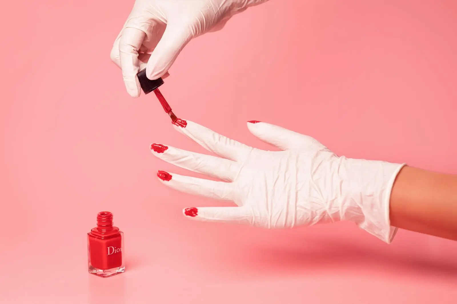 Red nail polish being applied