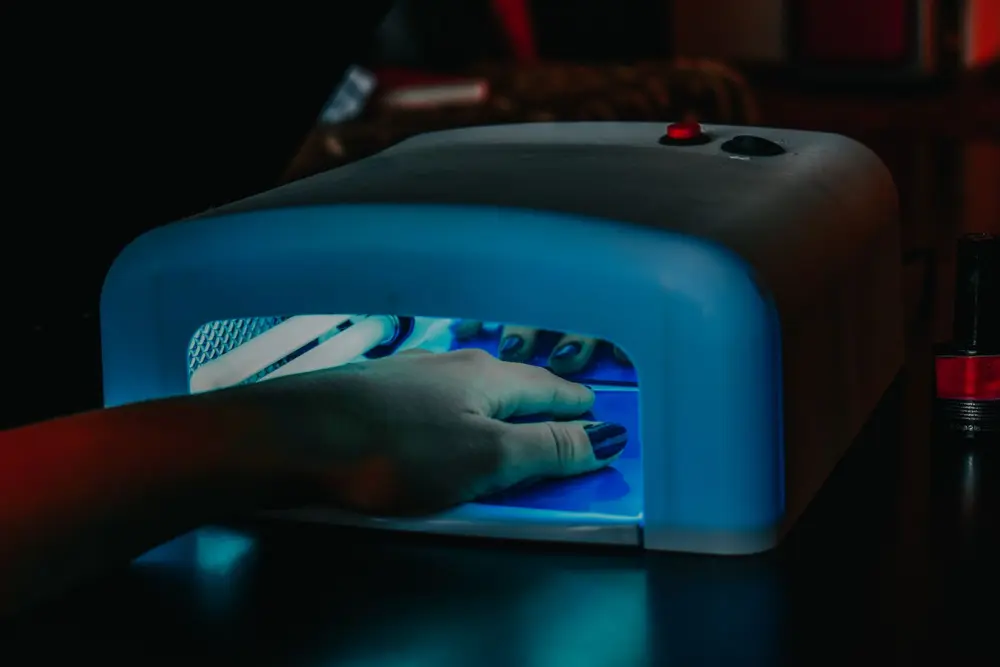 Gel manicure curing under a lamp